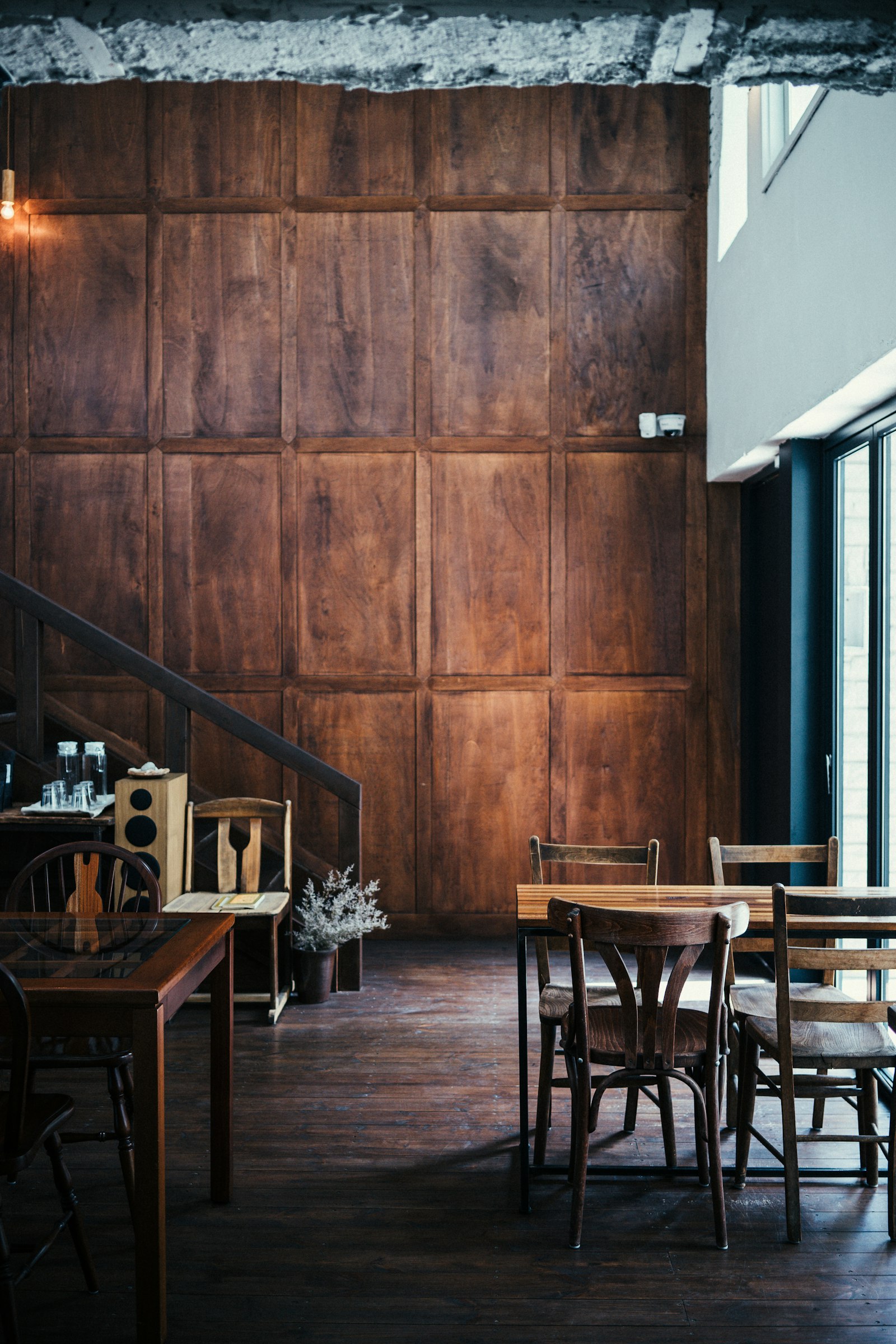 Interior cald al restaurantului Cireșar, cu lambriu de lemn masiv, scaune rustice și lumină caldă de seară